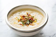 a white bowl filled with soup on top of a table