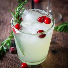 two glasses filled with ice and garnished with cranberry sprits