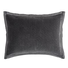 a black and grey pillow on a white background