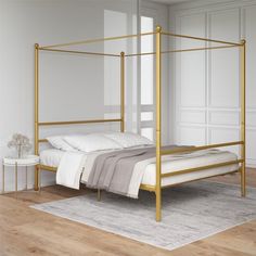 a gold metal bed frame in a white bedroom