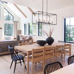 the dining room table is surrounded by black chairs