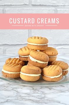 a stack of frosted custard creams sitting on top of a glass plate