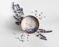 a cup filled with lavender on top of a table