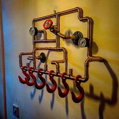 pipes and gauges are attached to the wall with red hoses hanging from them