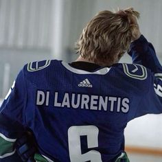 the back of a hockey player's jersey, with his hands on his head