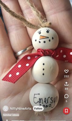 someone is holding two snowmen in their hand with the word merry written on them