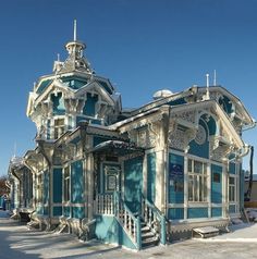 a blue and white building with snow on the ground