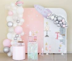 a room filled with balloons and decorations on the wall