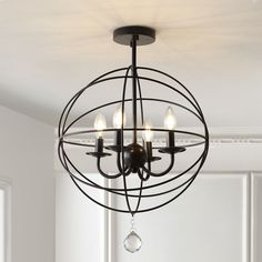 a chandelier with three lights hanging from it's center and an orb design