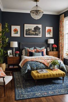 a bedroom decorated in blue and orange with pictures on the wall above the bed, along with a yellow footstool