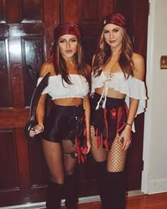 two women dressed in pirate costumes posing for the camera