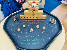 a black tray topped with lots of toys on top of a table