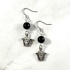 These Medusa earrings are the perfect accessory to show your love for the Greek myths in a subtle way! Made with onyx gemstone and a Medusa charm.  Made with fishhook style earrings. I offer both a standard and hypoallergenic option for the hooks. The standard is stainless steel and the hypoallergenic is 925 sterling silver plated. Ships in a jewelry box so it's ready to be give as a gift. All materials are lead and nickel free. Charm is made with zinc alloy.  Earrings will be disinfected before shipment but should also be cleaned every time before wearing. Medusa Earrings, Medusa Piercing Jewelry Spirit Adornments Piercing Jewlery, Greek Earrings, Greek Mythology Earrings, Ancient Greek Earrings, Medusa Pendant, Greek Mythology Jewelry, Mythology Jewelry, Greek Myths