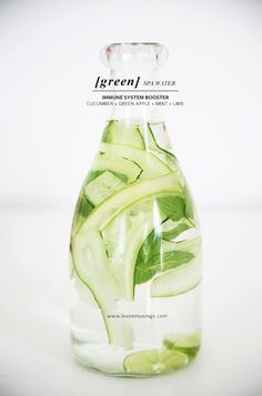 a glass bottle filled with sliced cucumbers