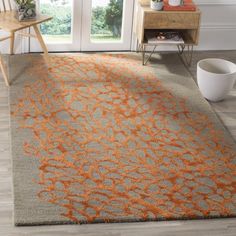 an orange and gray rug in a living room