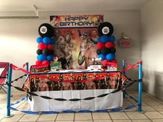 a birthday party with balloons and decorations in the shape of wrestling wrestlers on a table