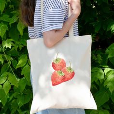 Are you looking for a strawberry tote bag for friends and family? Then this cute tote bag with strawberry design good be a nice gift for them for their birthday. Surprise a garden or fruit lover with this cottagecore inspired tote bag in the spring. Tote bag. Cover all your grab and go needs with these long handle tote bags while being eco-conscious. These tote bags feature reinforced stitching on handles for more stability. Your unique designs will stand out on these 100% cotton fabric tote bags.  - Reinforced stitching on handles - Capacity 10 litres - 100% cotton - 3 - 5  oz/yard², 100 - 170  g/m² Your order: *Before paying the order please check the colour of the tote bag you want *Check the address where the product will be send to *If you have any questions, please ask them before yo Red Bag With Strawberry Print As Gift, Rectangular Bag With Strawberry Print As Gift, Rectangular Bags With Strawberry Print As Gift, Rectangular Strawberry Print Bag As A Gift, Rectangular Bags With Strawberry Print For Gifts, Rectangular Strawberry Print Bag For Gifts, Cute Strawberry Print Tote Bag, Strawberry Print Tote Bag For Daily Use, Everyday Tote Bag With Strawberry Print