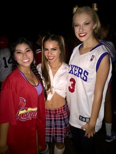 three girls in cheerleader outfits posing for the camera