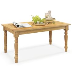 a wooden table topped with a plate of food next to a wine glass and knife