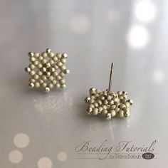 two pairs of white beaded earrings sitting on top of a table next to each other