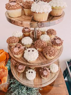 three tiered cake stand with cupcakes on it