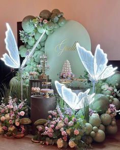 a table topped with lots of cake and flowers