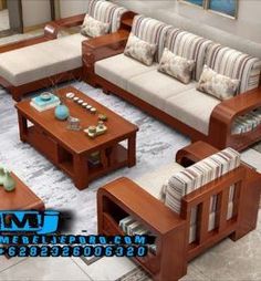 a living room filled with lots of furniture and pillows on top of a carpeted floor