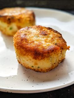 two small pieces of food on a white plate