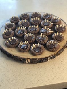 chocolate chip cookies arranged in the shape of eyes on a tree slice