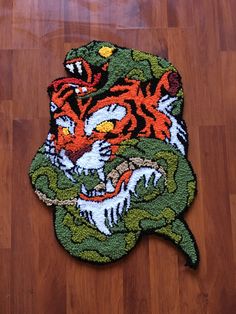 a rug with a tiger on it sitting on a wooden floor