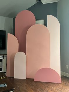 a living room with pink and white walls