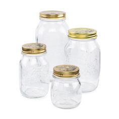 four glass jars with gold lids