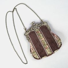 Introducing our captivating collection of Chatelaine purses, inspired by the elegance of the Victorian era.Available in three sizes—Large, Medium, and Small—these purses offer versatility and style. The Large and Medium sizes can be used as both a clutch and a crossbody purse, as we provide two chains for each size: 50" and 13" in length. This allows you to effortlessly switch between crossbody and clutch styles.Let's focus on the Chatelaine Large Crossbody Purse:With a frame width of 6.25" and a height of 8", this purse comfortably holds larger items like the iPhone 14 Pro Max and a passport. It features a small slip pocket for cards or small essentials, and the 1.5" bottom depth provides ample space for your necessities.The Large Crossbody Purse includes two chains, each with brass hooks Elegant Brown Coin Purse, Vintage Brown Pouch Evening Bag, Elegant Brown Rectangular Coin Purse, Elegant Rectangular Coin Purse, Elegant Rectangular Coin Purse For Daily Use, Elegant Rectangular Travel Coin Purse, Elegant Crossbody Travel Coin Purse, Elegant Crossbody Coin Purse For Travel, Vintage Brown Coin Purse With Removable Pouch