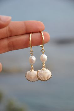 "Gold Dangle shell and pearl hoop earrings, 18k gold filled hoop earings, summer earrings, minimalist hoops, shell earrings, custom earrings The SHEILA earings are perfect for this spring summer. The hoops are in gold filled with fresh water pearl and a real shell with gold filled contour. My jewelry are hand made and done with high quality material. They are hypoallergenic and nickel free. DETAILS: ♥ Lenght 6cm (2.36\") , width  1.6cm (0.62\") ♥ Materials: gold filled 18k, fresh water pearl, shell ♥ style : minimalist If you need any futher information or customisation, feel free to contact me.  THANK YOU" Cheap Beach Season Earrings, Cheap Summer Beach Earrings, White 14k Gold Filled Hoop Earrings, Dainty Gold Hoop Pearl Earrings, Minimalist 14k Gold-filled Hoop Earrings With Pearl Charm, Beachy Jewelry, Preppy Jewelry, Seashell Jewelry, Summer Earrings