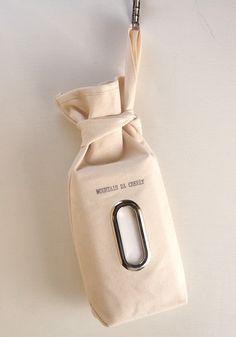 a white bag with a metal clip hanging from it