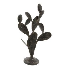 a small metal cactus plant sitting on top of a table