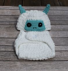 a crocheted stuffed animal laying on top of a wooden floor