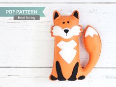 an orange fox stuffed animal sitting on top of a white wooden floor with the words, free pattern hand sewing