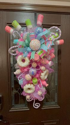 a door hanger decorated with donuts and candy