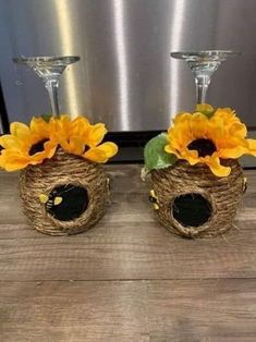 two wine glasses with sunflowers in them