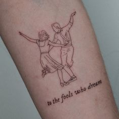 a couple dancing together with the words to the fools who dream on their arm