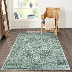 a chair and mirror in a room with hardwood floors, white walls and wooden flooring