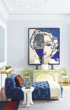 a living room filled with furniture and a painting on the wall