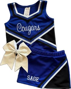 a cheerleader outfit with a bow on the side and slogan saying, cougas