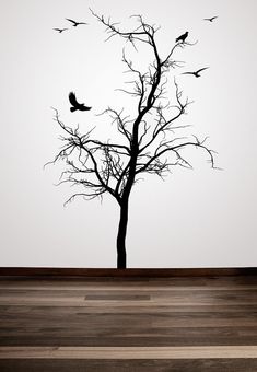 a tree with birds flying in the sky next to it's branches on a wall