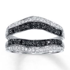 a black and white diamond ring with two rows of diamonds on each band, set in 18k white gold