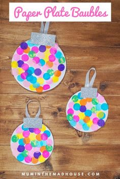 three paper plate baubles with glitter on them