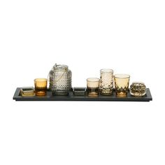 an assortment of glassware on a tray