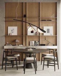 a modern dining room with wooden shelves and chairs, an overhead lamp and artwork on the wall