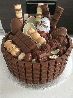 there is a cake decorated with chocolate and candies in the shape of a basket